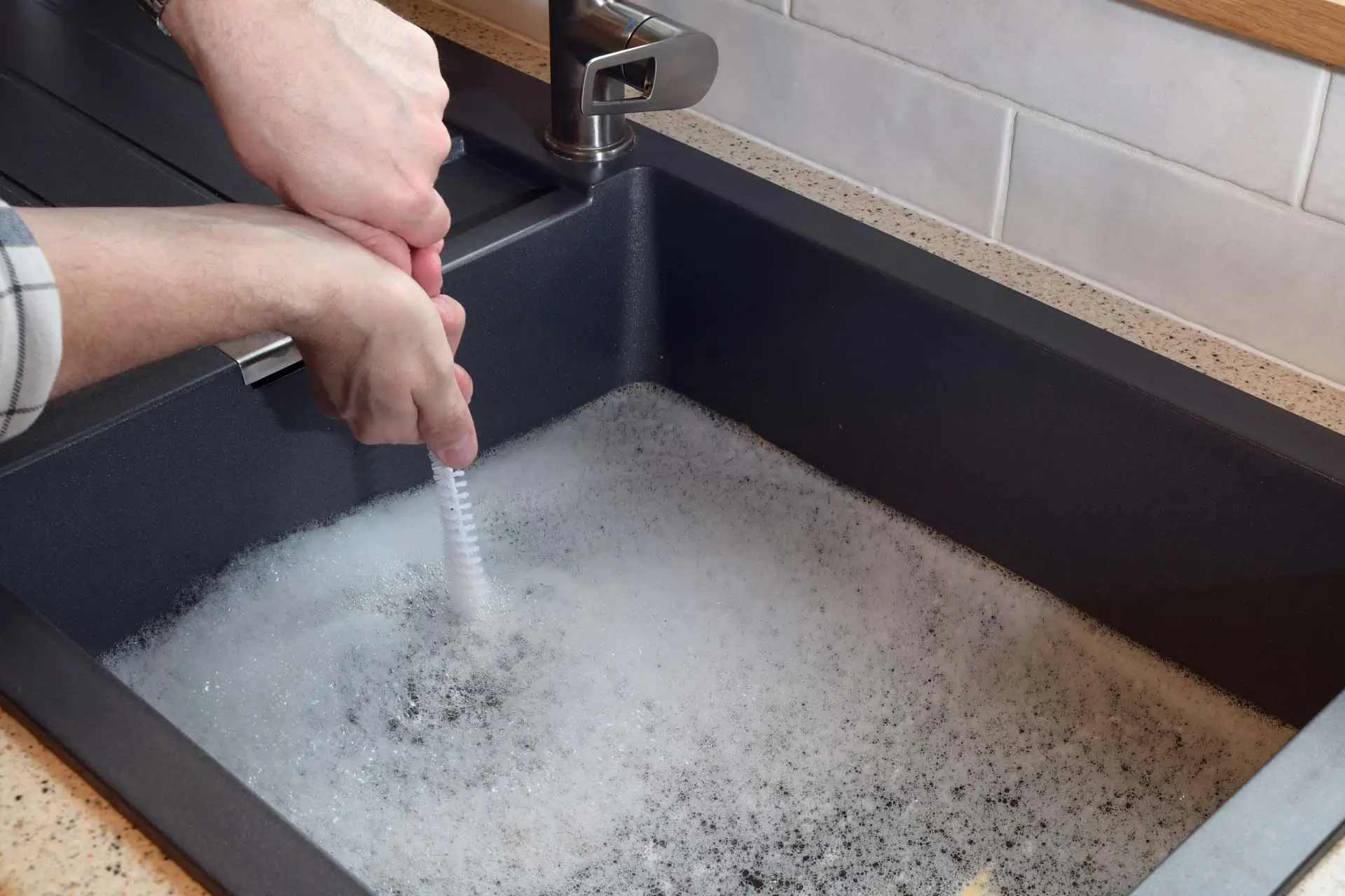 Plumber replacing damaged bathroom faucet in Margate home during routine plumbing service visit